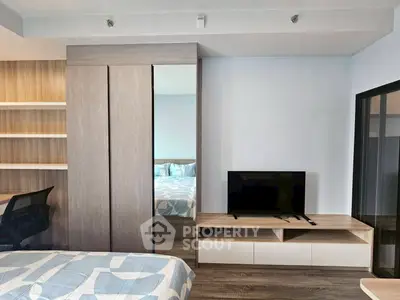 Modern bedroom with stylish decor, built-in wardrobe, and sleek TV unit