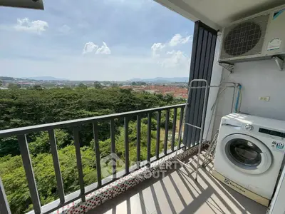 Scenic balcony view with washing machine and lush greenery