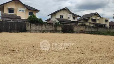 Spacious vacant land plot with potential for residential development, surrounded by suburban homes.