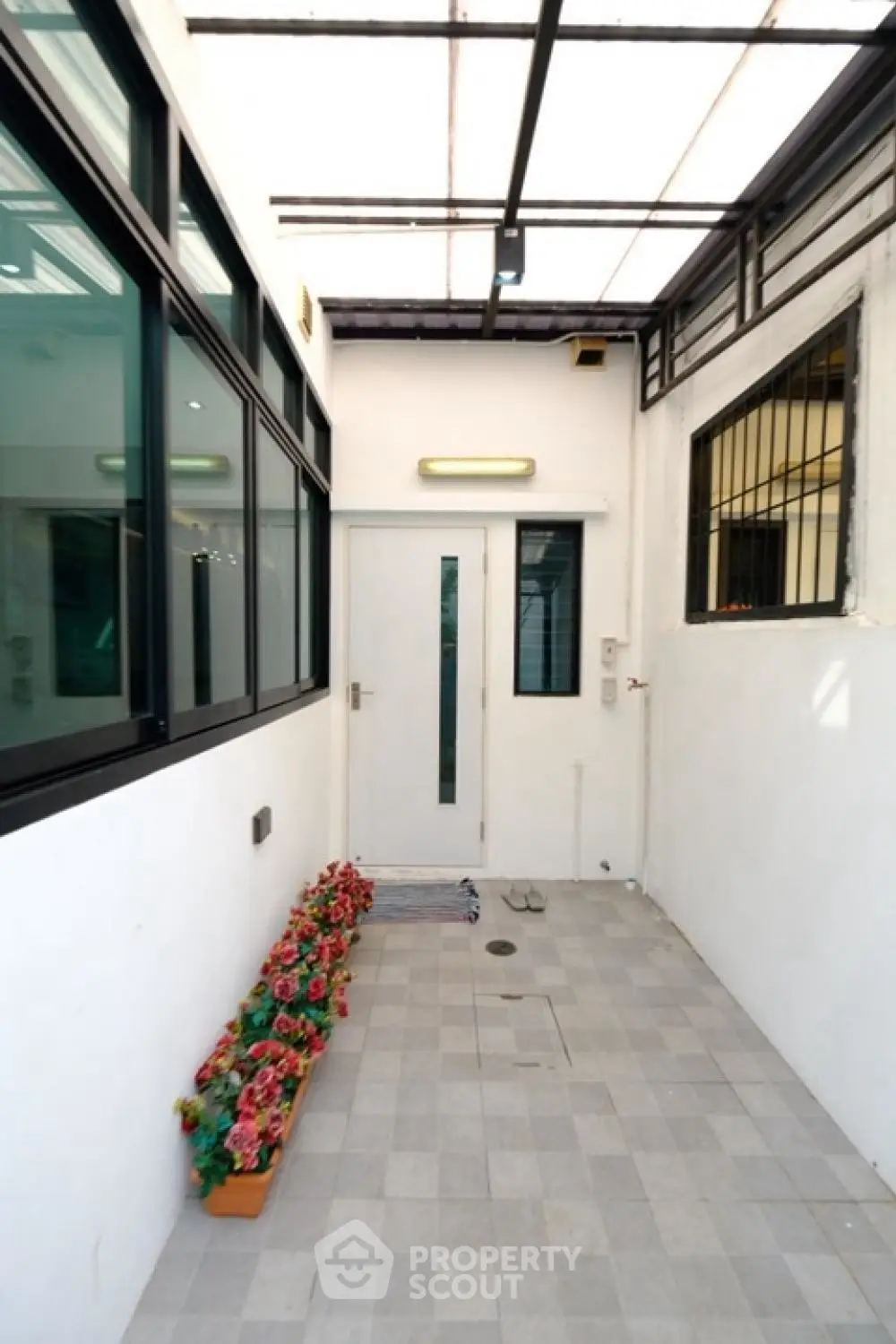 Charming entrance with modern glass windows and flower accents