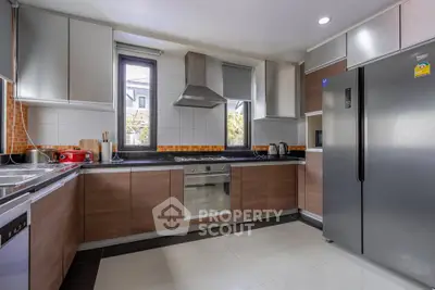 Modern kitchen with sleek cabinetry, stainless steel appliances, and ample natural light.
