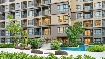 Modern apartment building with pool and lush greenery, ideal for urban living.
