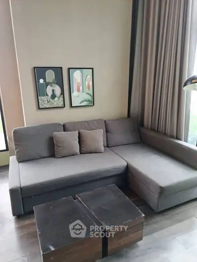 Modern living room with stylish gray sofa and contemporary wall art