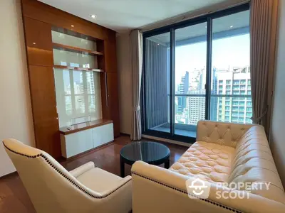 Elegant living room with polished hardwood floors, modern furniture, and floor-to-ceiling windows offering an urban view.