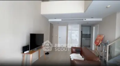 Modern living room with high ceiling and stylish leather sofa