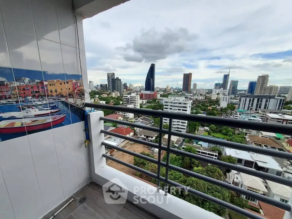 Stunning cityscape view from high-rise balcony with modern railing and vibrant wall art.