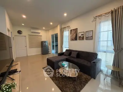 Modern living room with stylish decor, cozy sofa, and natural light, perfect for relaxation and entertainment.