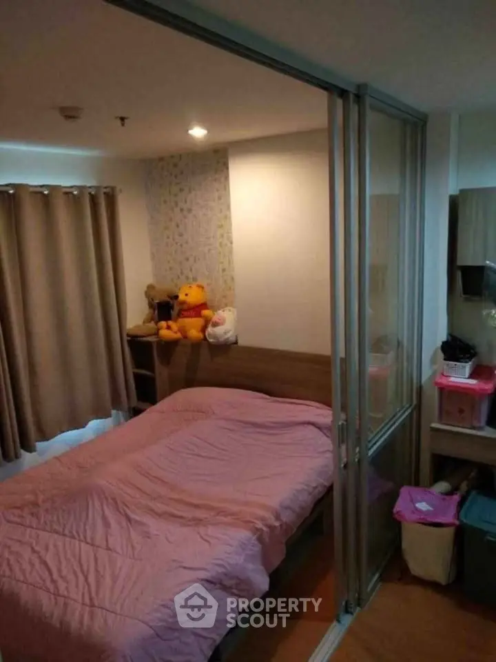 Cozy bedroom with sliding glass doors and plush toys, perfect for a comfortable living space.