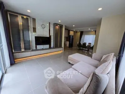Spacious modern living room with elegant decor and large windows for natural light.