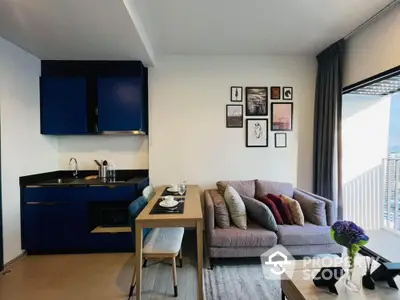 Chic modern living space with open layout kitchen, plush sofa, and stylish decor, boasting natural light and a cozy ambiance perfect for urban living.