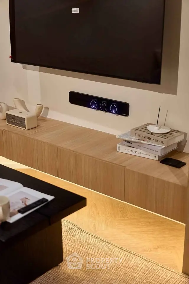 Modern living room with sleek wooden console, stylish decor, and wall-mounted TV for a contemporary lifestyle.
