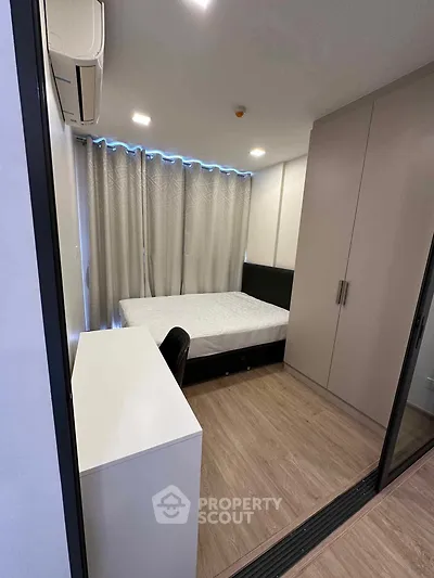 Modern bedroom with sleek design, featuring a comfortable bed, built-in wardrobe, and stylish desk.