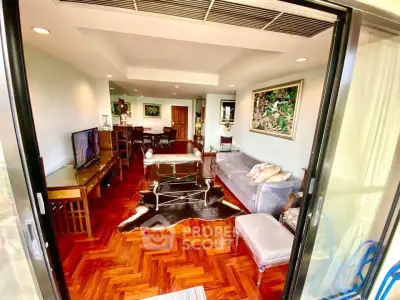 Spacious living room with elegant decor and parquet flooring, perfect for modern living.