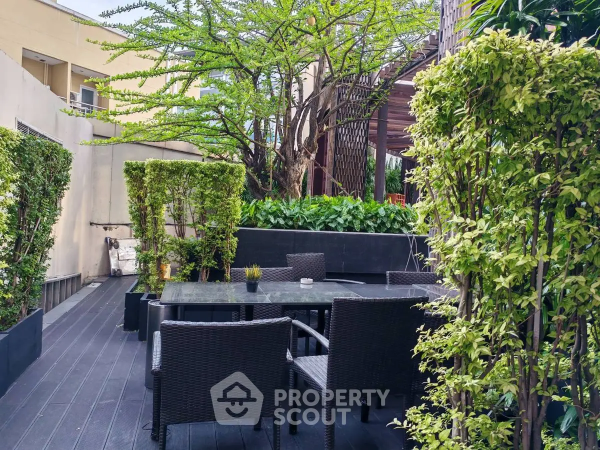 Luxurious outdoor garden with elegant dining set and lush greenery