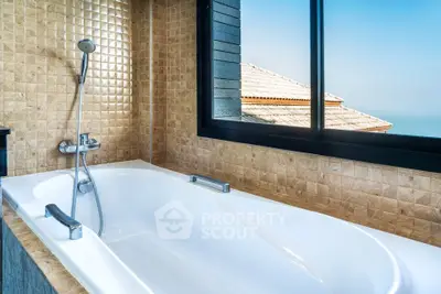 Luxurious bathroom with modern bathtub and scenic window view.