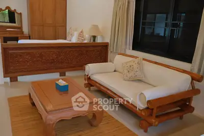 Charming living room with elegant wooden furniture and cozy decor, perfect for relaxation and comfort.