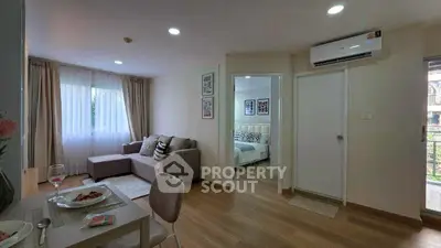 Modern living room with cozy sofa and dining area, leading to a bright bedroom, perfect for urban living.