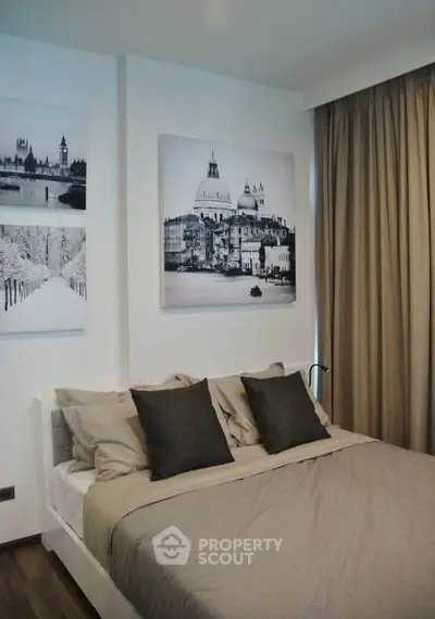 Cozy bedroom with elegant decor and large wall art, perfect for relaxation.