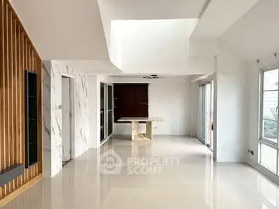 Spacious modern living room with marble accents and large windows