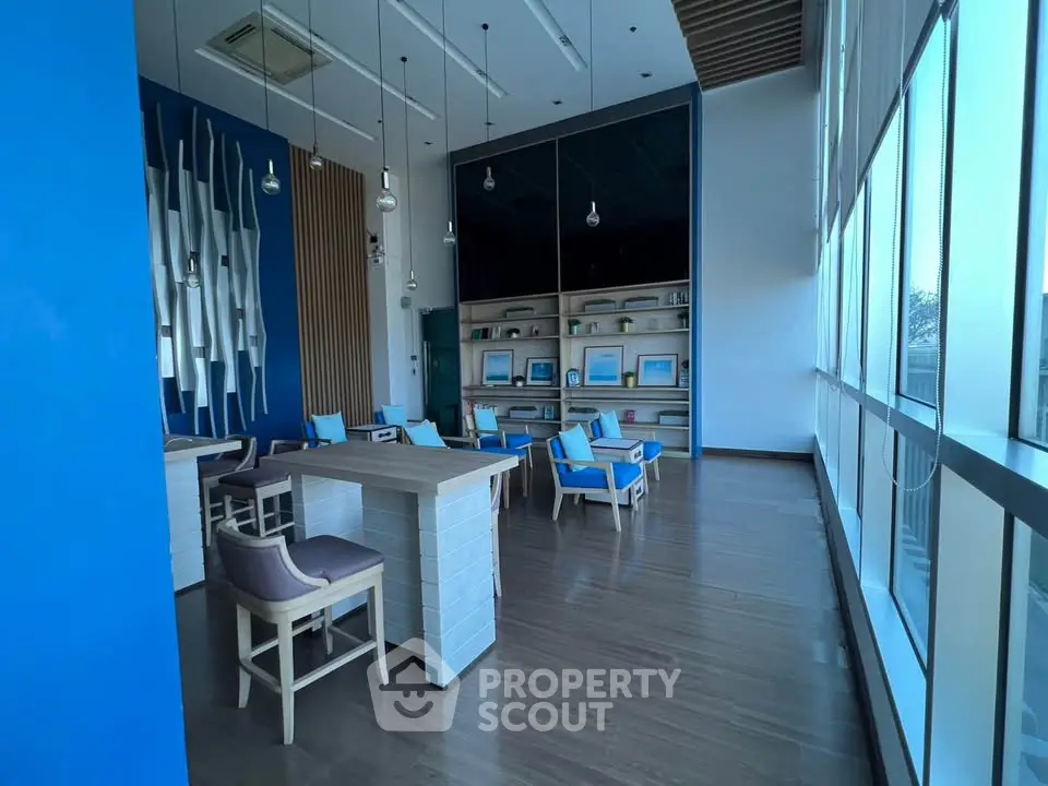 Modern co-working space with stylish decor and large windows for natural light.