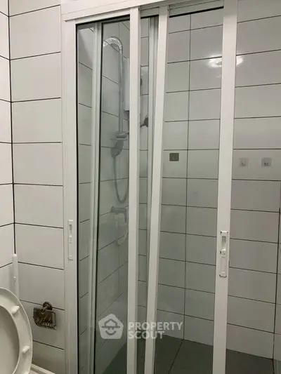 Modern bathroom with sliding shower door and tiled walls
