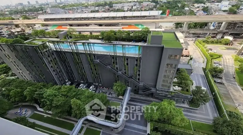 Modern building with rooftop pool and lush greenery in urban setting