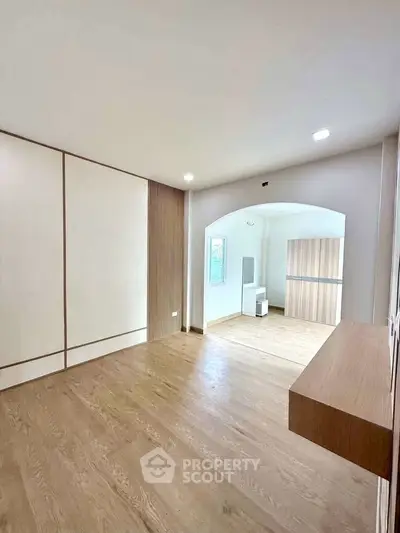 Spacious modern living room with wooden flooring and elegant design