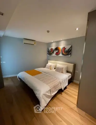 Modern bedroom with stylish decor and cozy ambiance in a contemporary apartment.