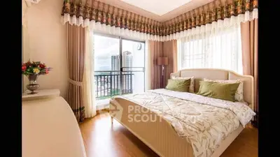 Elegant bedroom with plush bedding, large windows offering city views, and tasteful decor creating a serene urban oasis.