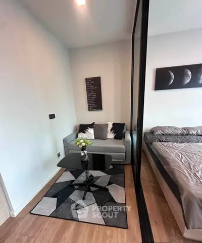 Cozy modern bedroom with stylish decor and comfortable seating area