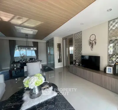 Luxurious living room with modern decor and elegant dining area, featuring a stylish open layout.