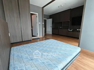 Spacious modern bedroom with wooden flooring and minimalist design
