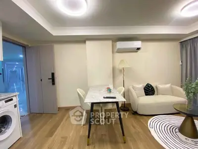Modern living room with stylish furniture and integrated washing machine, perfect for urban living.
