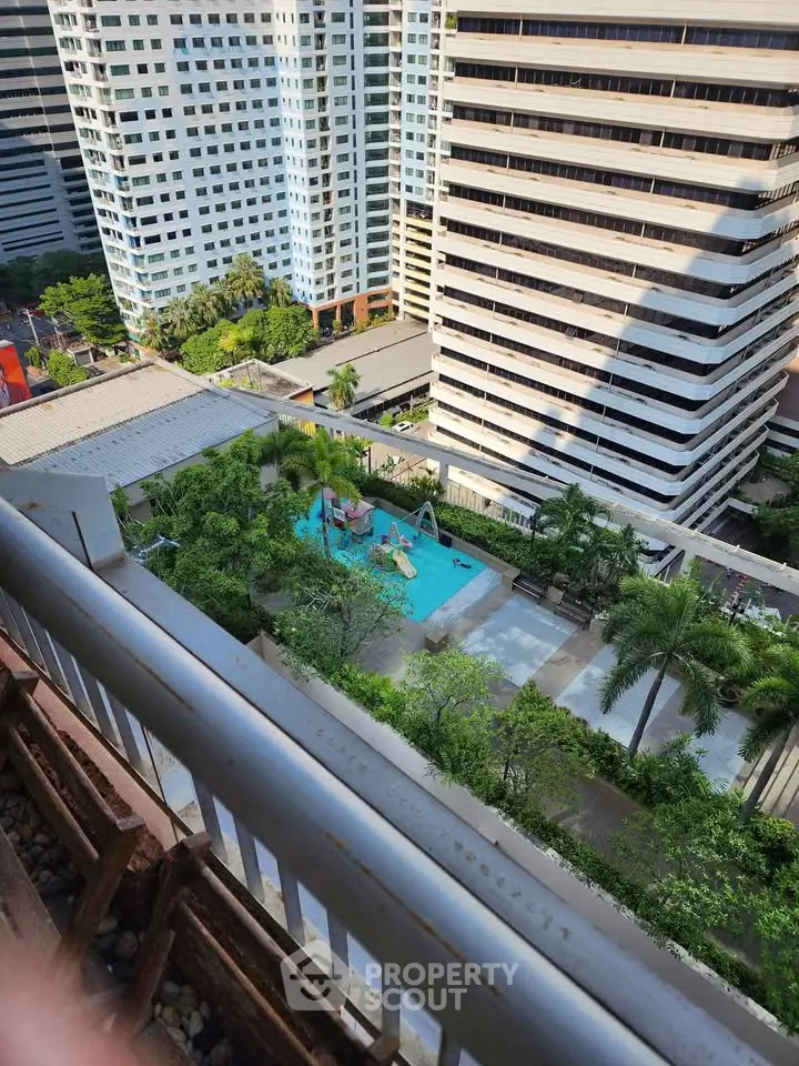Stunning aerial view of modern urban residential complex with lush greenery and inviting pool area.