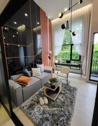 Modern living room with high ceiling, stylish decor, and large windows overlooking greenery.