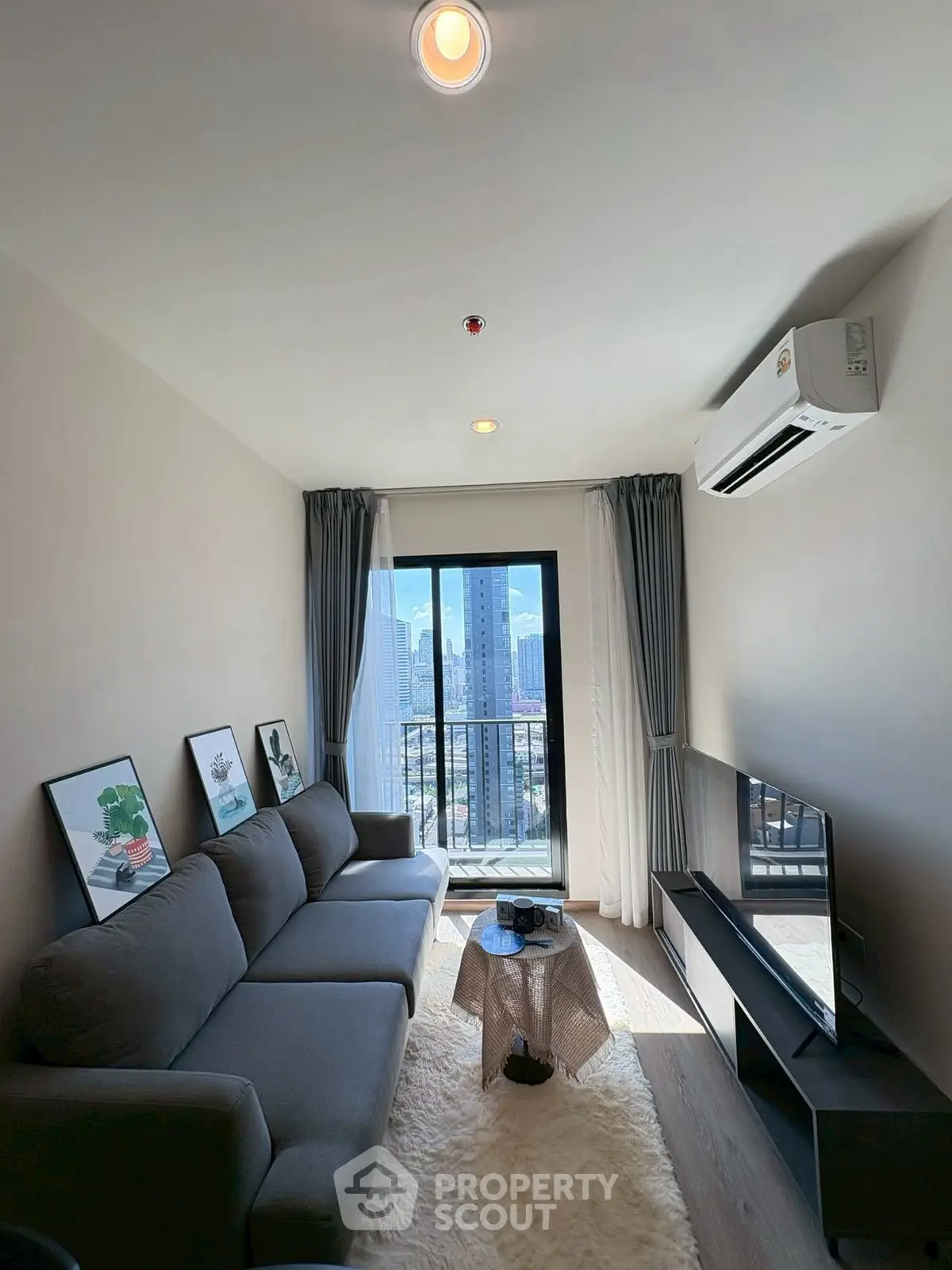 Modern living room with city view, stylish decor, and cozy ambiance.