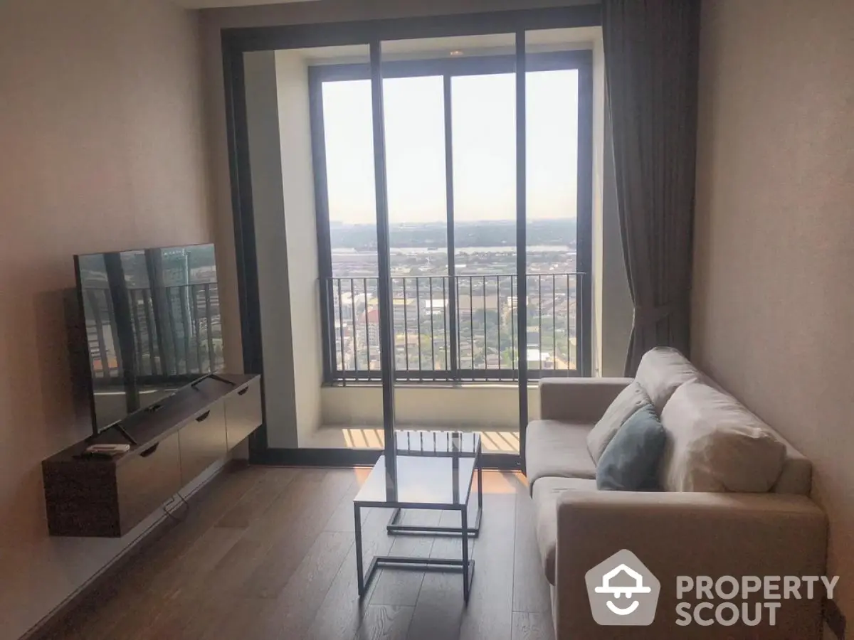 Modern living room with floor-to-ceiling windows and stunning city view.