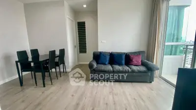 Modern living room with sleek furniture and city view balcony