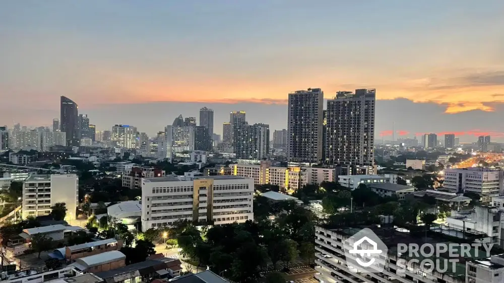 Stunning cityscape view of urban skyline at dusk with high-rise buildings and vibrant sunset.