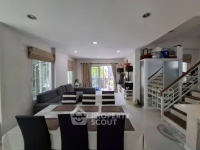 Spacious living room with modern decor and large windows for natural light.