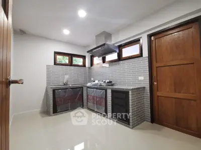 Modern kitchen with sleek cabinetry and gas stove in a stylish home