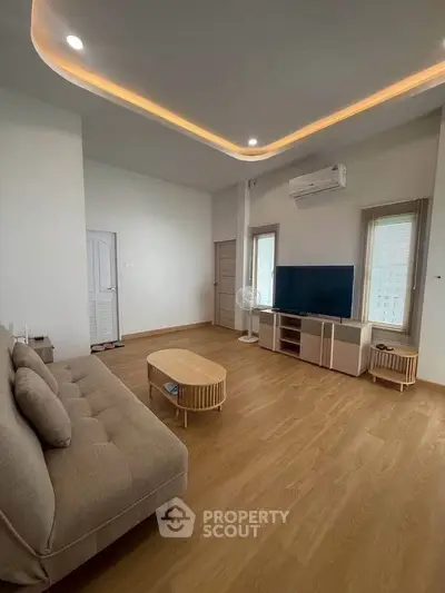 Spacious modern living room with stylish furniture and ambient lighting