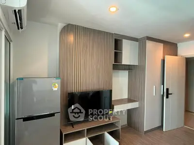 Modern living room with built-in wooden cabinetry and sleek appliances