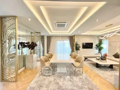 Luxurious open-plan living and dining area with elegant decor and modern lighting.