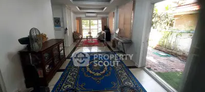 Spacious living room with elegant rugs and garden view, perfect for relaxation and entertaining.