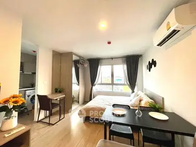 Modern studio apartment with open layout, featuring a cozy bedroom, dining area, and compact kitchen.