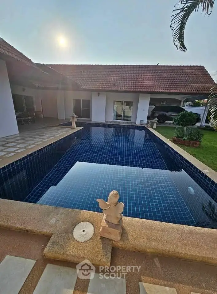 Luxurious villa with a stunning pool and charming garden, perfect for relaxation and entertainment.
