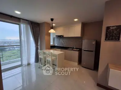 Modern kitchen with open layout and balcony view in a stylish apartment.