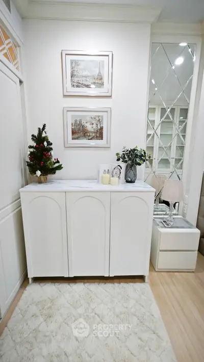 Chic interior with elegant white cabinet and decorative accents in a cozy living space.