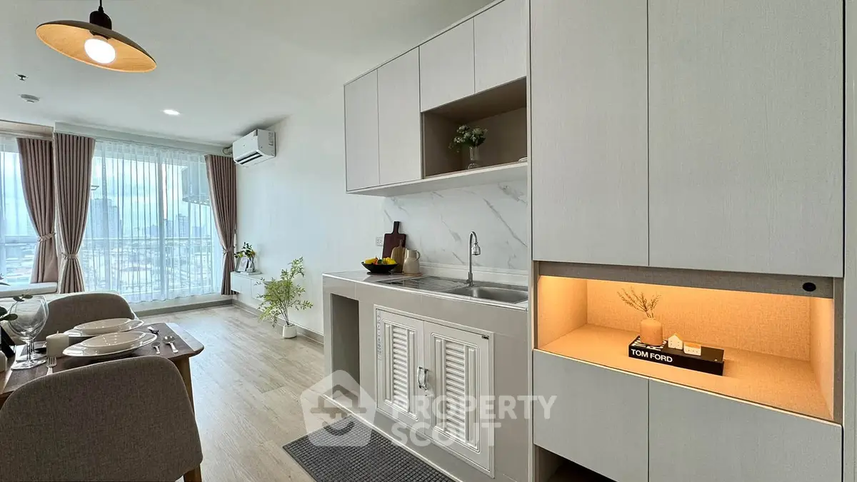 Modern open-plan kitchen and dining area with sleek cabinetry and city view.